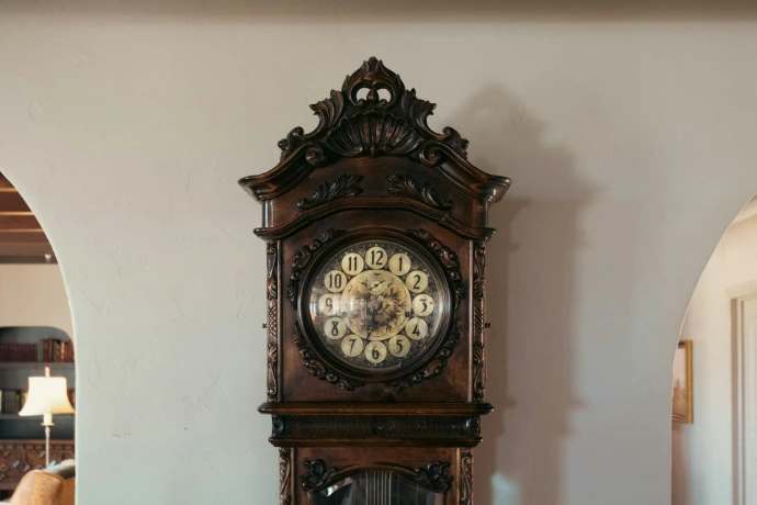 A grandfather clock sitting on top of a table